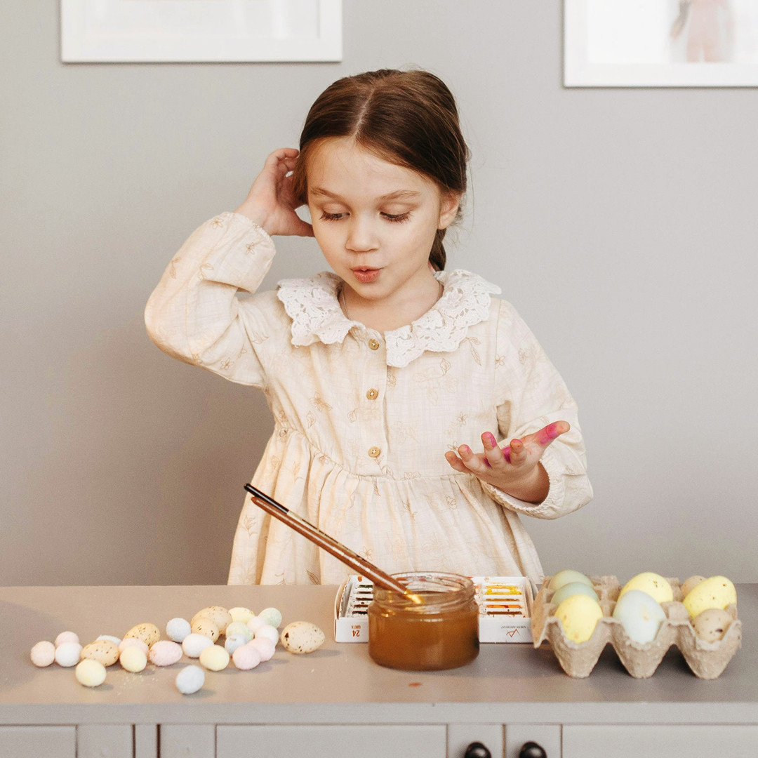 A little girl gets ready to decorate her Easter eggs.